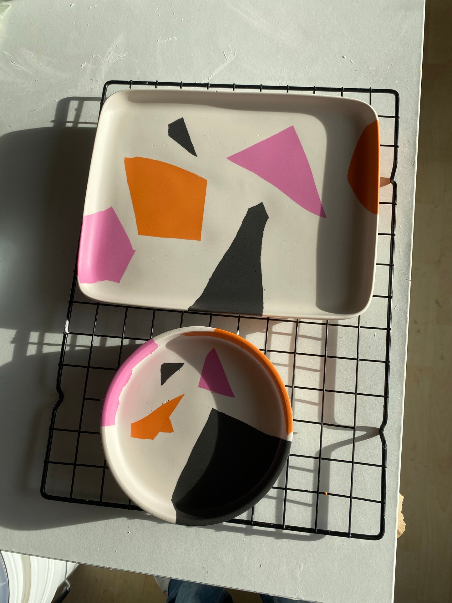 B. White, pink, orange and black geometric Plate
